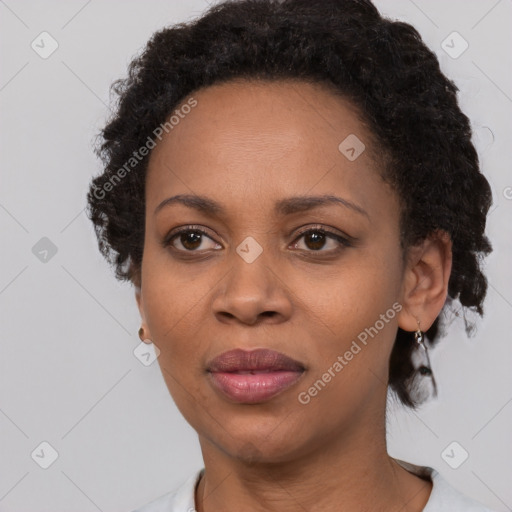 Joyful black adult female with short  black hair and brown eyes