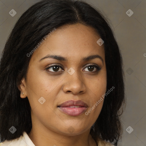 Joyful black young-adult female with long  brown hair and brown eyes