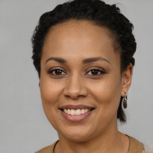 Joyful latino young-adult female with short  brown hair and brown eyes