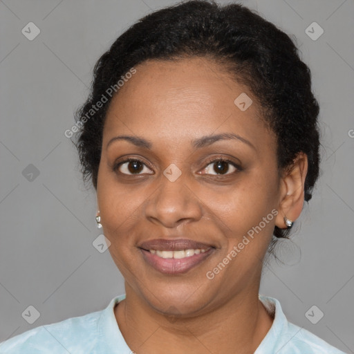 Joyful black adult female with short  brown hair and brown eyes