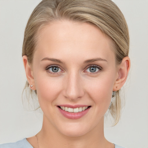 Joyful white young-adult female with medium  brown hair and blue eyes