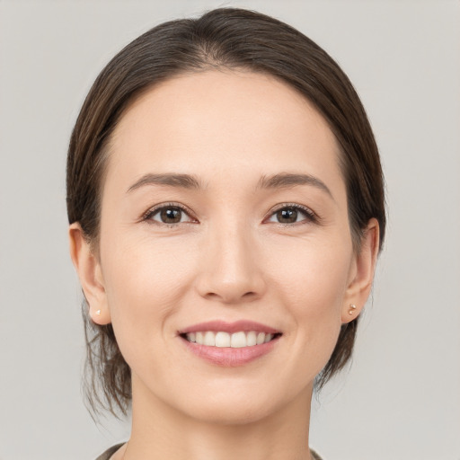 Joyful white young-adult female with medium  brown hair and brown eyes