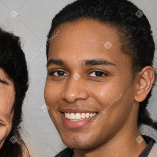 Joyful black young-adult male with short  brown hair and brown eyes