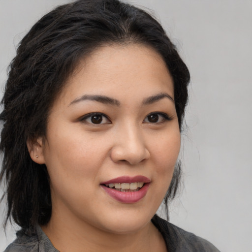 Joyful asian young-adult female with medium  brown hair and brown eyes