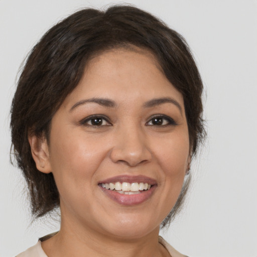 Joyful white young-adult female with medium  brown hair and brown eyes