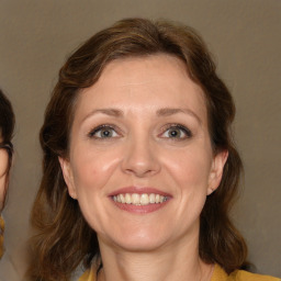 Joyful white adult female with medium  brown hair and brown eyes