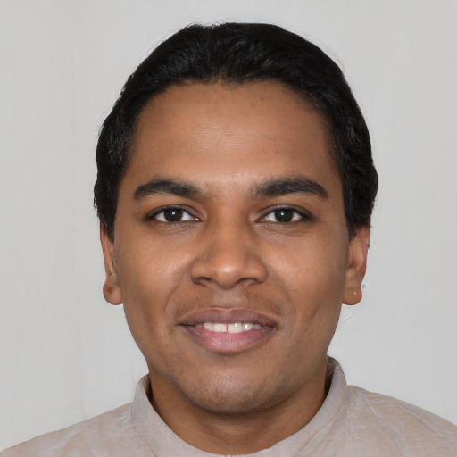 Joyful black young-adult male with short  black hair and brown eyes