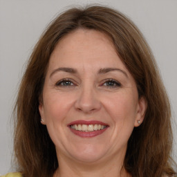 Joyful white adult female with long  brown hair and brown eyes