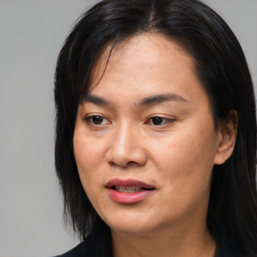 Joyful asian young-adult female with long  black hair and brown eyes