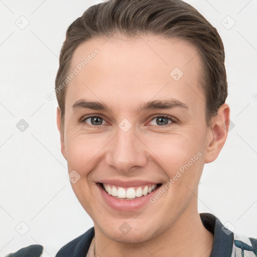 Joyful white young-adult male with short  brown hair and brown eyes