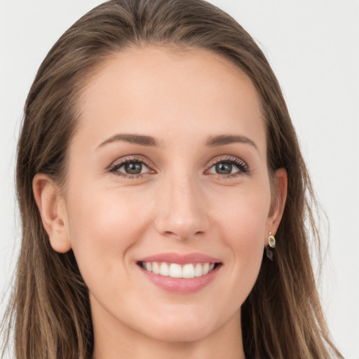 Joyful white young-adult female with long  brown hair and grey eyes