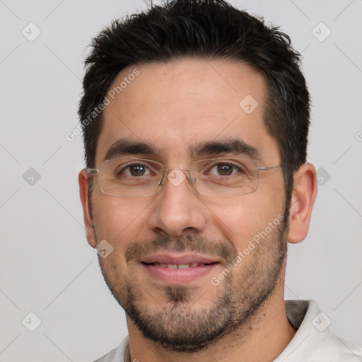 Joyful white adult male with short  black hair and brown eyes