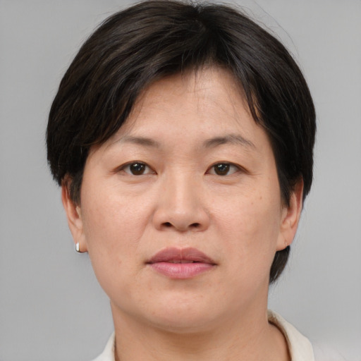Neutral asian adult female with short  brown hair and brown eyes