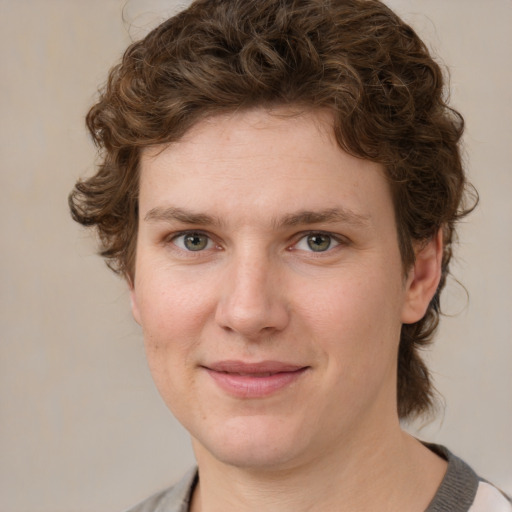 Joyful white young-adult female with medium  brown hair and green eyes