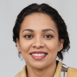 Joyful latino young-adult female with medium  brown hair and brown eyes