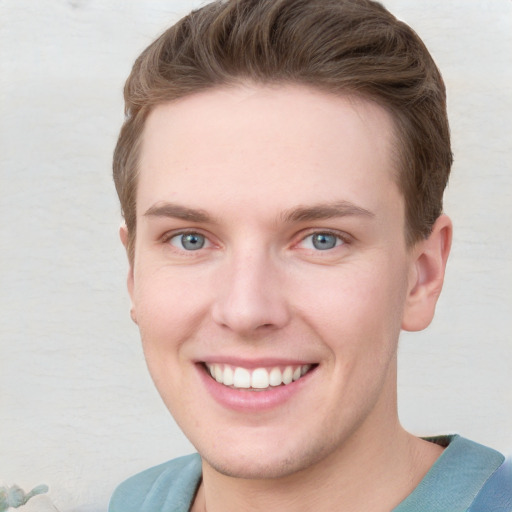 Joyful white young-adult male with short  brown hair and blue eyes