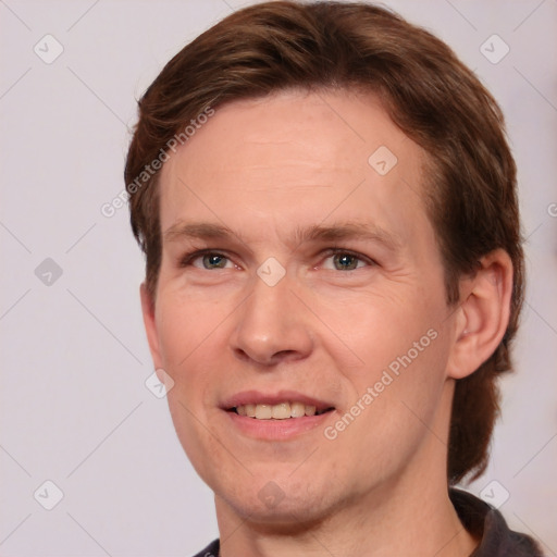 Joyful white adult male with short  brown hair and grey eyes