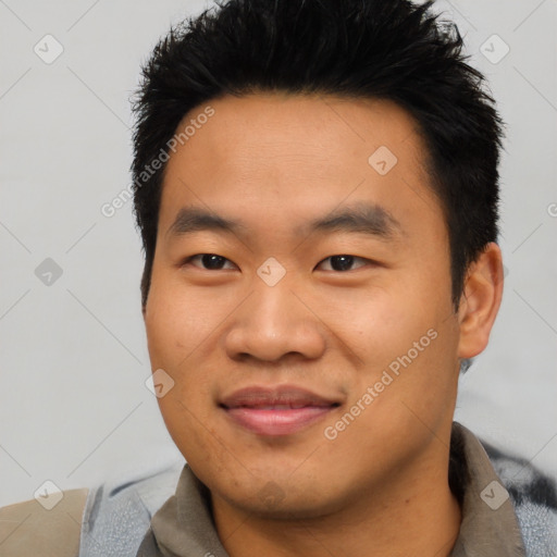 Joyful asian young-adult male with short  black hair and brown eyes