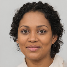 Joyful black adult female with medium  brown hair and brown eyes