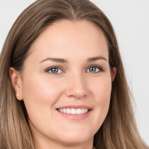 Joyful white young-adult female with long  brown hair and grey eyes