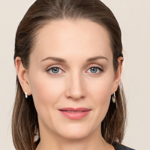 Joyful white young-adult female with long  brown hair and grey eyes