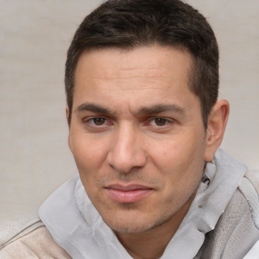 Joyful white adult male with short  brown hair and brown eyes