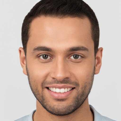 Joyful white young-adult male with short  brown hair and brown eyes