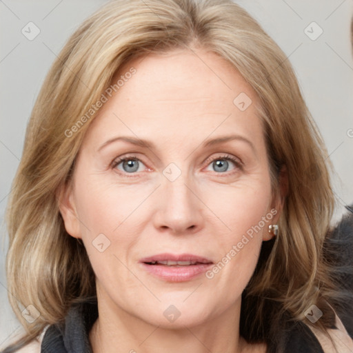 Joyful white adult female with medium  brown hair and blue eyes