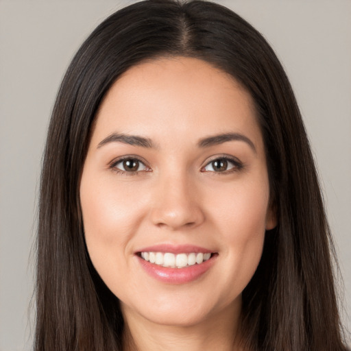 Joyful white young-adult female with long  brown hair and brown eyes