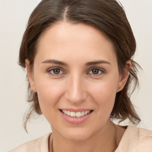 Joyful white young-adult female with medium  brown hair and brown eyes