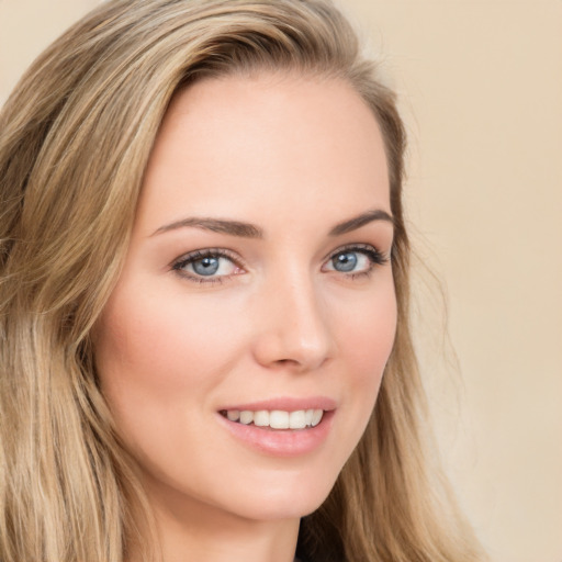 Joyful white young-adult female with long  brown hair and green eyes