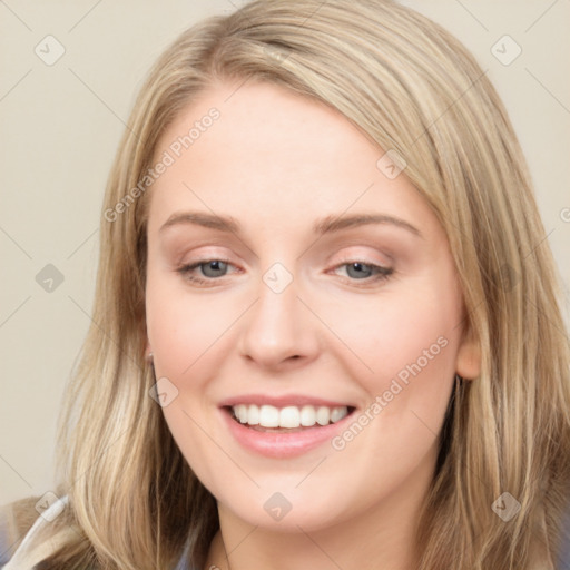 Joyful white young-adult female with long  brown hair and blue eyes