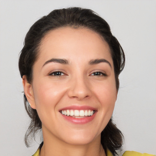 Joyful white young-adult female with medium  brown hair and brown eyes