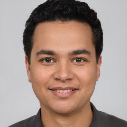 Joyful white young-adult male with short  black hair and brown eyes