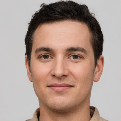 Joyful white young-adult male with short  brown hair and brown eyes