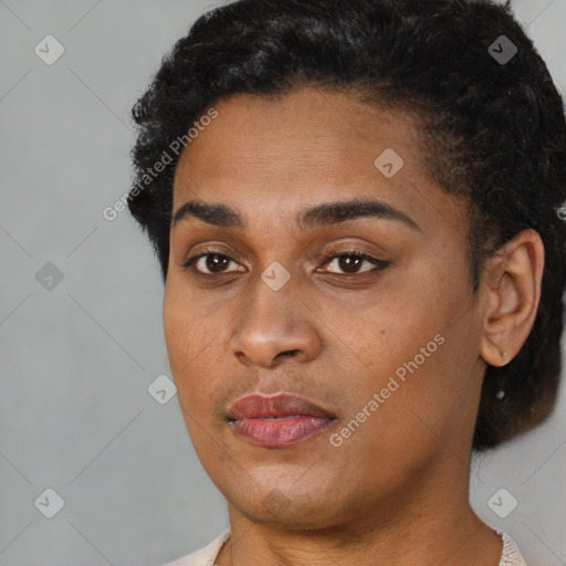 Joyful latino young-adult female with short  black hair and brown eyes