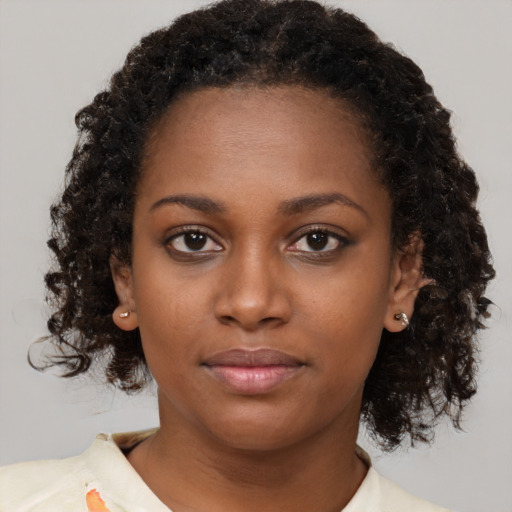 Neutral black young-adult female with medium  brown hair and brown eyes