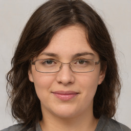 Joyful white adult female with medium  brown hair and grey eyes