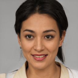 Joyful latino young-adult female with medium  brown hair and brown eyes