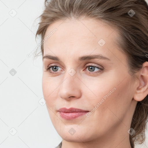 Joyful white young-adult female with medium  brown hair and blue eyes