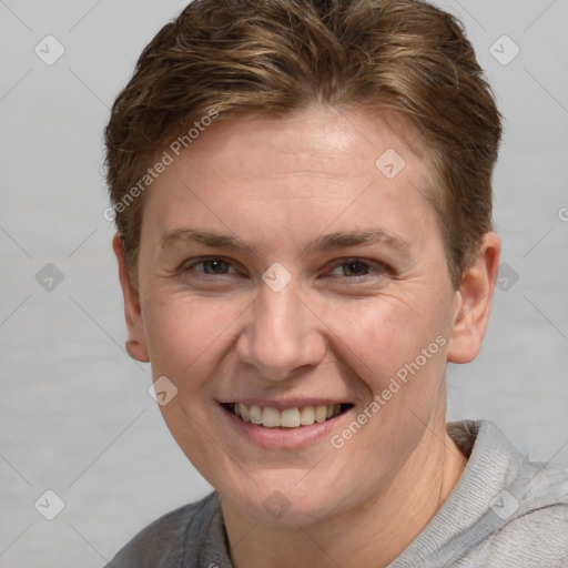 Joyful white adult female with short  brown hair and grey eyes