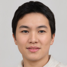 Joyful asian young-adult male with short  black hair and brown eyes