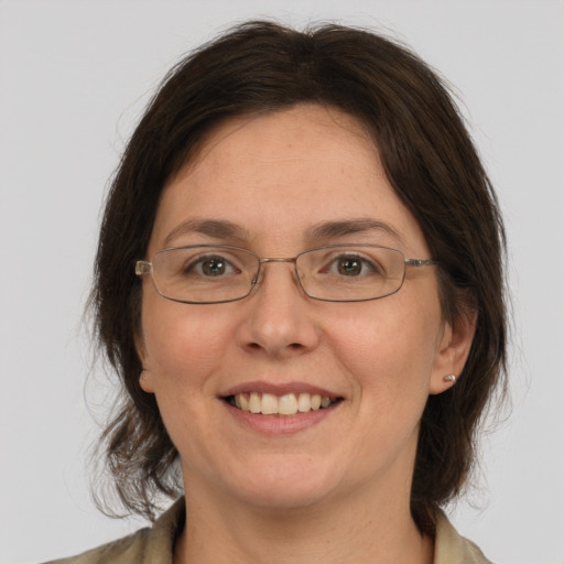 Joyful white adult female with medium  brown hair and brown eyes