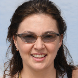 Joyful white adult female with medium  brown hair and brown eyes