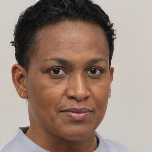 Joyful black adult female with short  brown hair and brown eyes