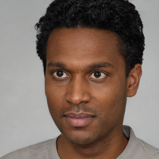 Neutral black young-adult male with short  black hair and brown eyes