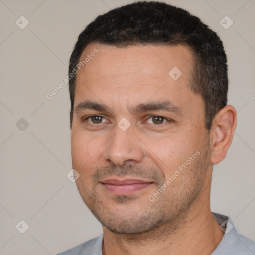 Joyful white adult male with short  black hair and brown eyes