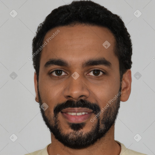 Joyful black young-adult male with short  black hair and brown eyes