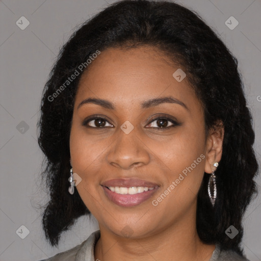 Joyful black young-adult female with long  brown hair and brown eyes