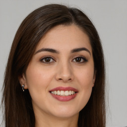 Joyful white young-adult female with long  brown hair and brown eyes